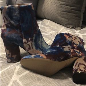 Katy Perry maroon and blue ankle boots.